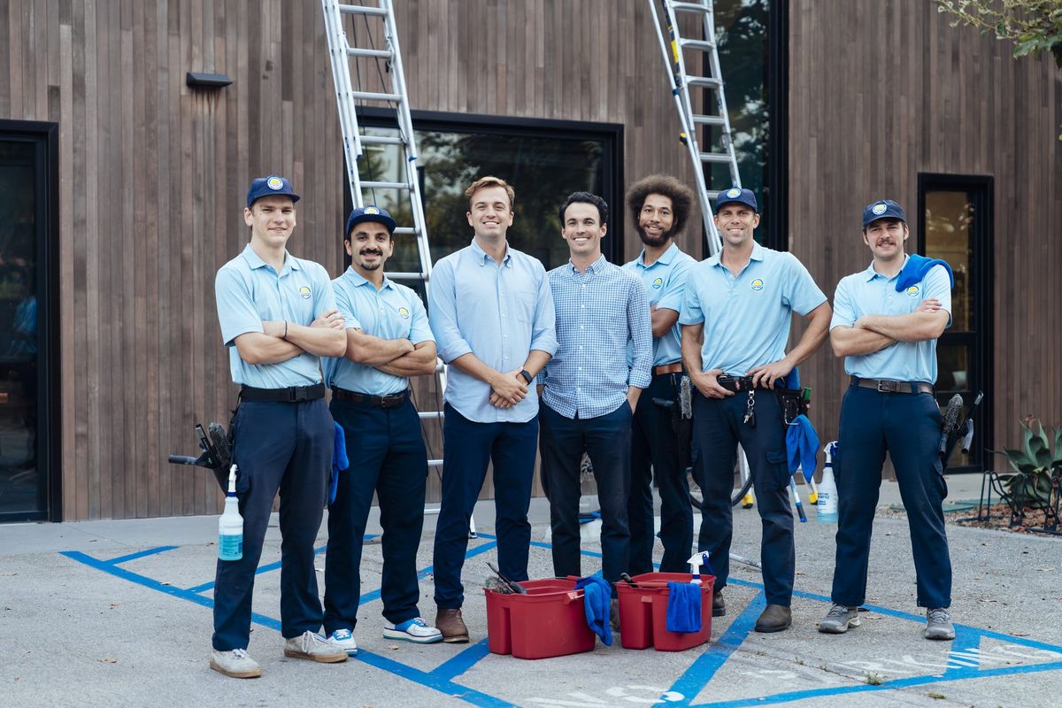 The Trip's Windows crew standing together in front of the branded van