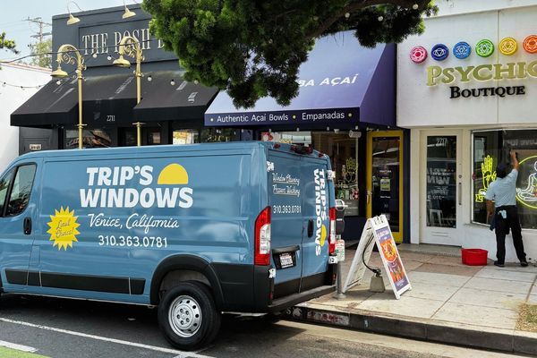 Trip's Windows van outside a gym and retail strip for commercial cleaning