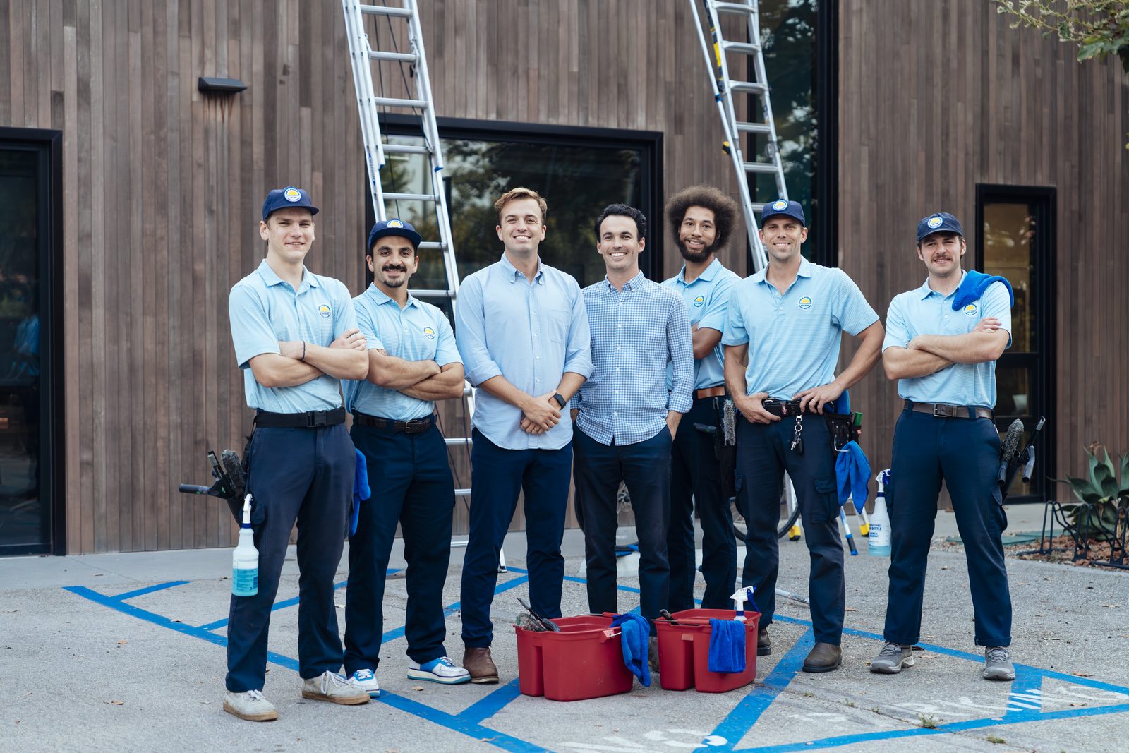 The Trip's Windows crew standing together with ladders and cleaning equipment in front of a modern Venice home